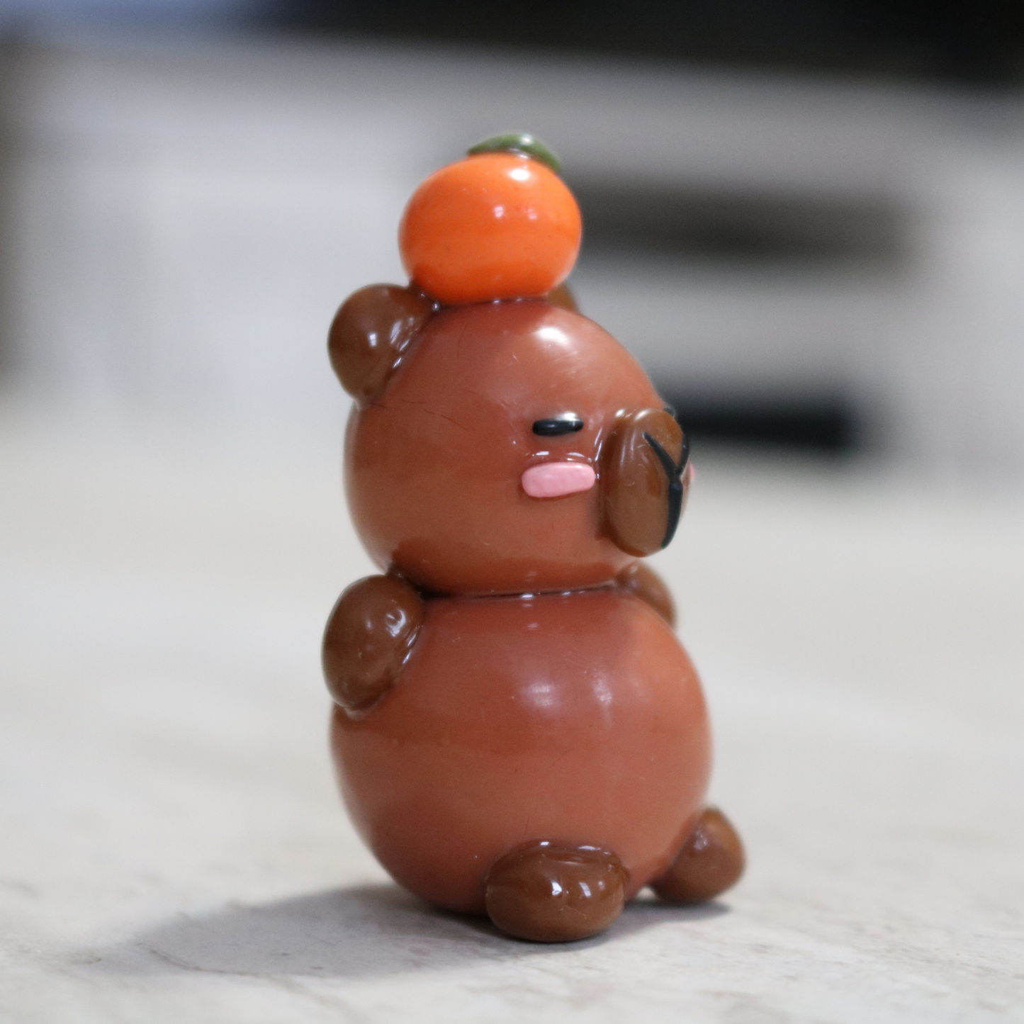 Capybara with an Orange Desk Friend