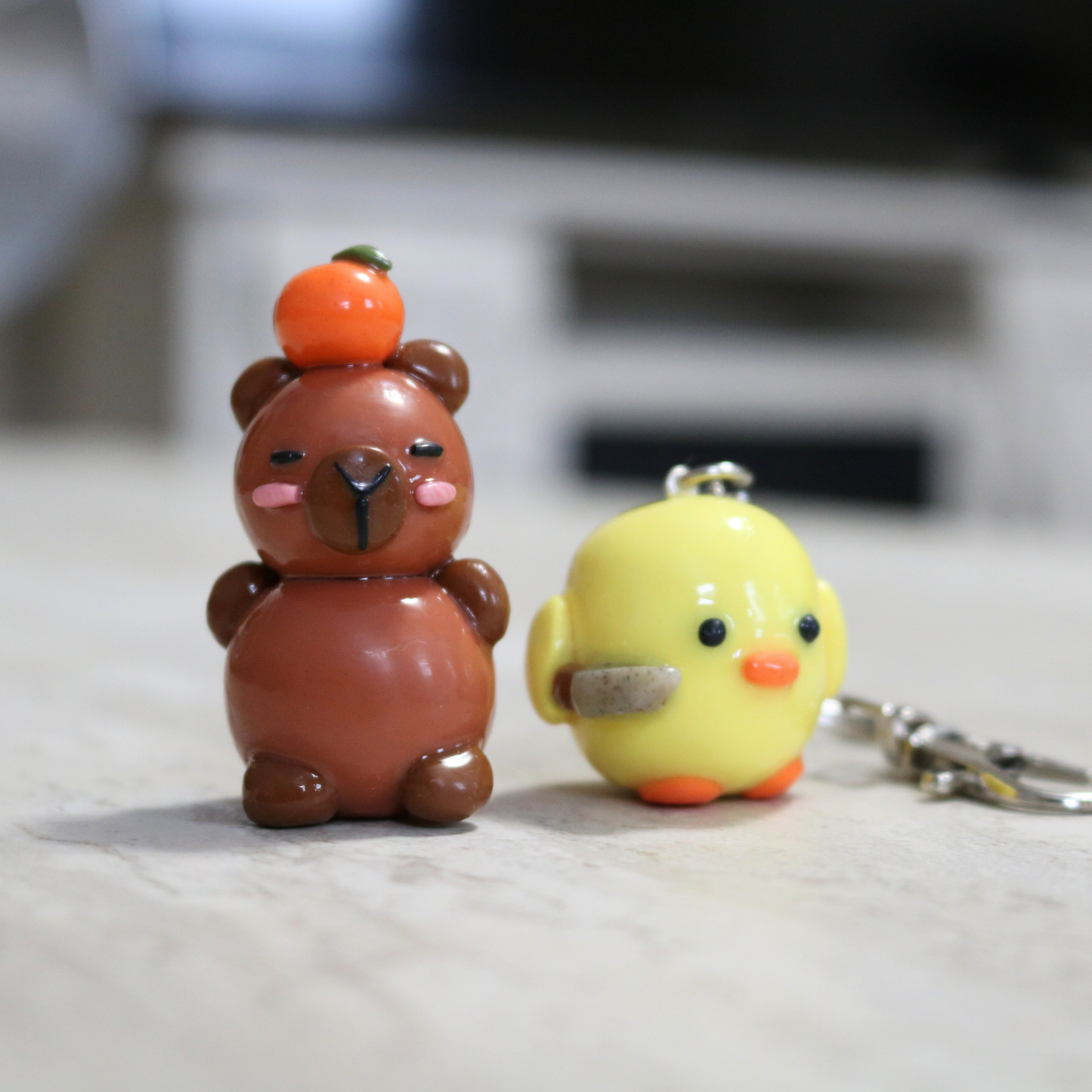 Capybara with an Orange Desk Friend
