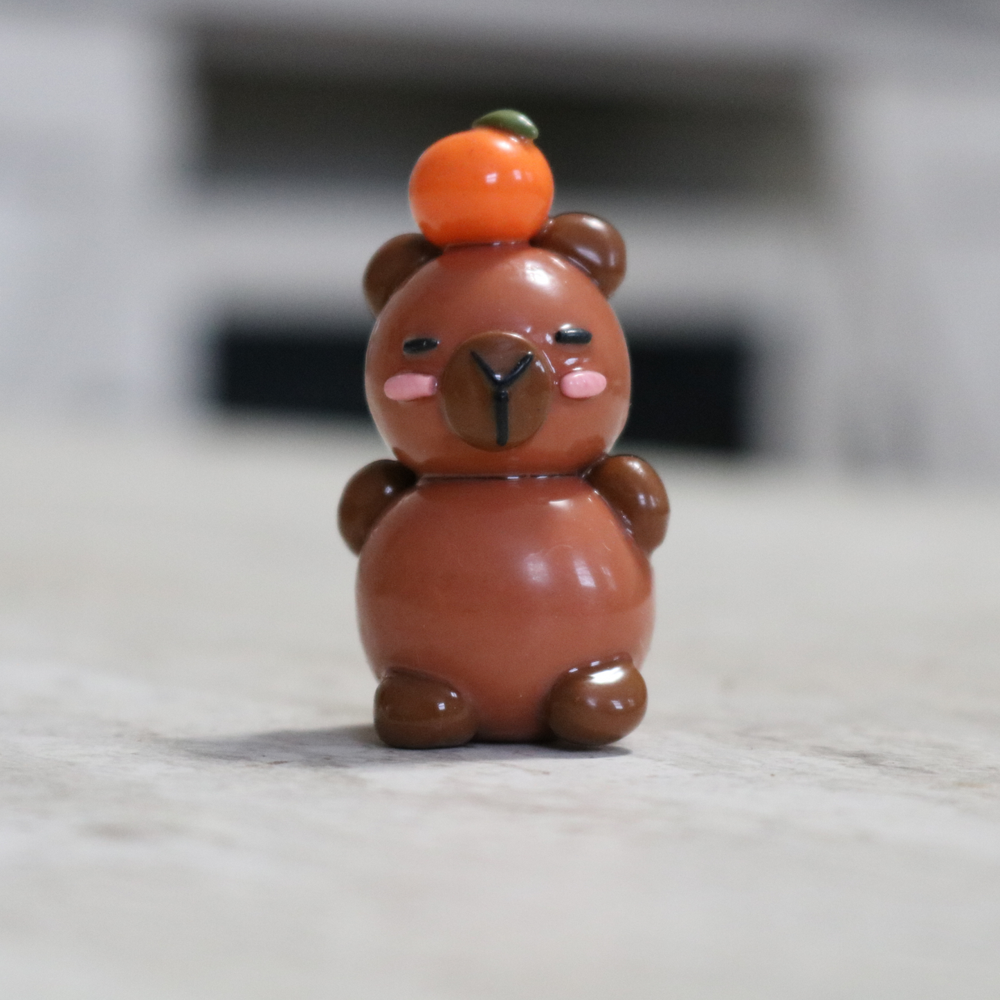 Capybara with an Orange Desk Friend