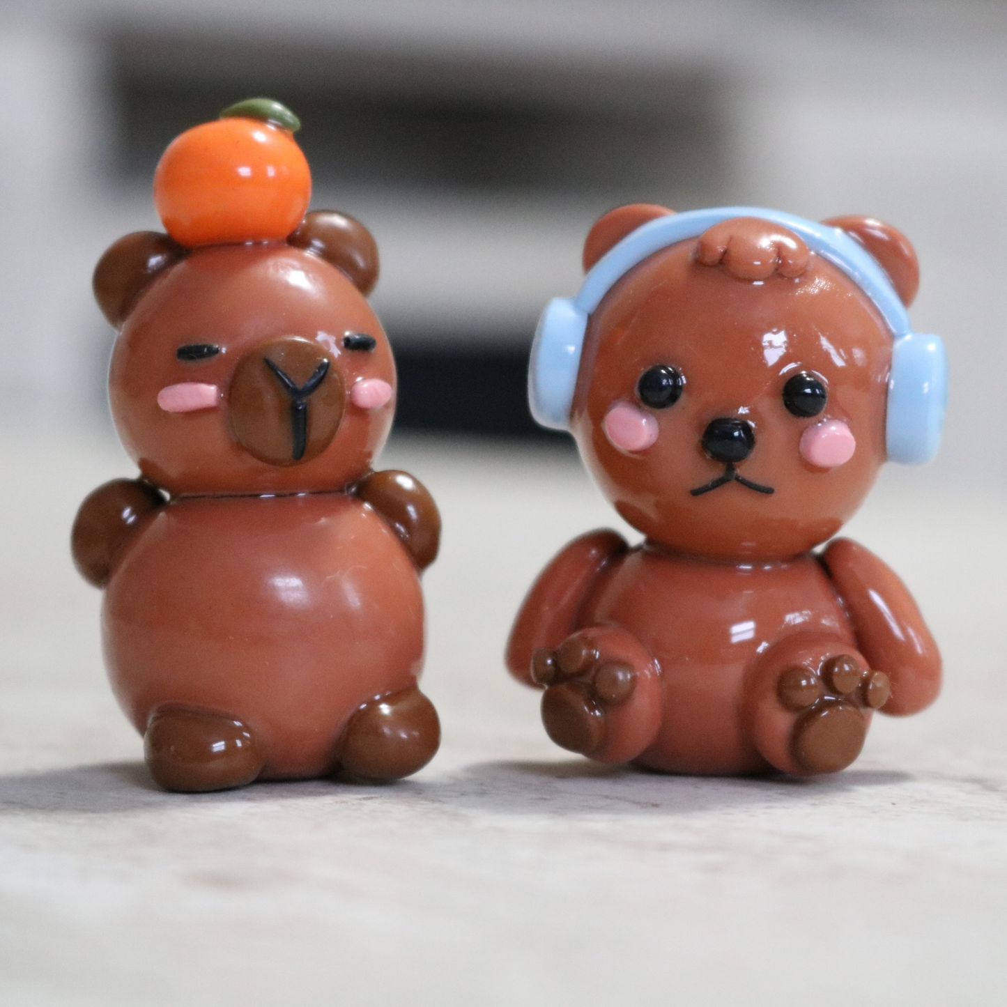 Capybara with an Orange Desk Friend