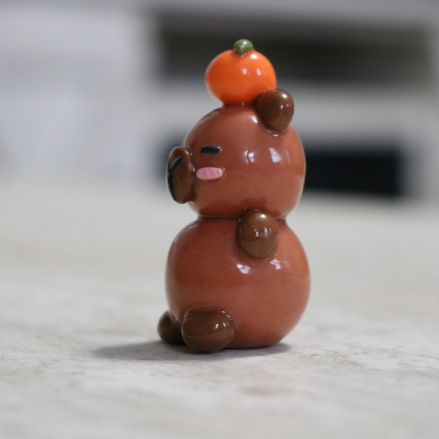 Capybara with an Orange Desk Friend